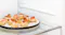 A plate of appetizers stored inside the fridge A plate of appetizers stored inside the fridge