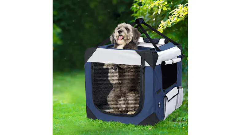Blue and grey PaWz Soft Pet Transport Crate with mesh panels and carry straps, displayed outdoors on grass Blue and grey PaWz Soft Pet Transport Crate with mesh panels and carry straps, displayed outdoors on grass