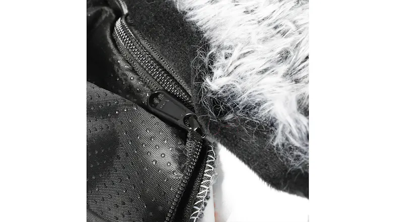Close-up of a pet bed zipper closure with a black non-slip base and charcoal grey plush fabric Close-up of a pet bed zipper closure with a black non-slip base and charcoal grey plush fabric