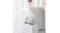 White pet waste bag with red drawstring handles lifted from a white self-cleaning litter box White pet waste bag with red drawstring handles lifted from a white self-cleaning litter box