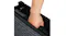 Close-up shot of a hand gripping the built-in handle of a folded black pet ramp with blue textured treading Close-up shot of a hand gripping the built-in handle of a folded black pet ramp with blue textured treading