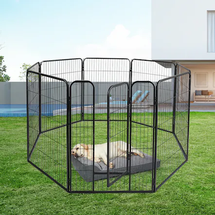 Angled front view of black PaWz metal pet playpen with an open gate and wire mesh panels on a grass lawn Angled front view of black PaWz metal pet playpen with an open gate and wire mesh panels on a grass lawn