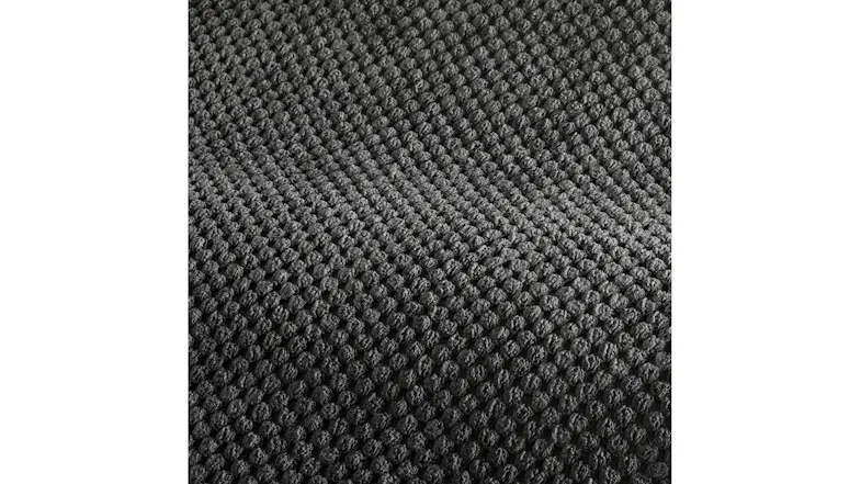 Close-up texture of dark grey corn-kernel corduroy fabric, showing a soft, bumpy, non-slip weave pattern Close-up texture of dark grey corn-kernel corduroy fabric, showing a soft, bumpy, non-slip weave pattern