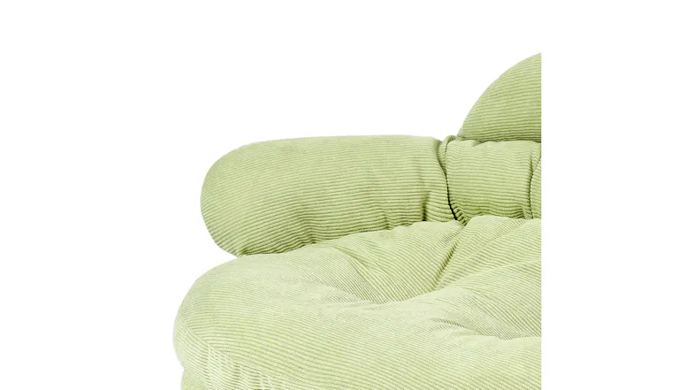 Close-up of the rounded upholstered armrest on the light green pet sofa Close-up of the rounded upholstered armrest on the light green pet sofa