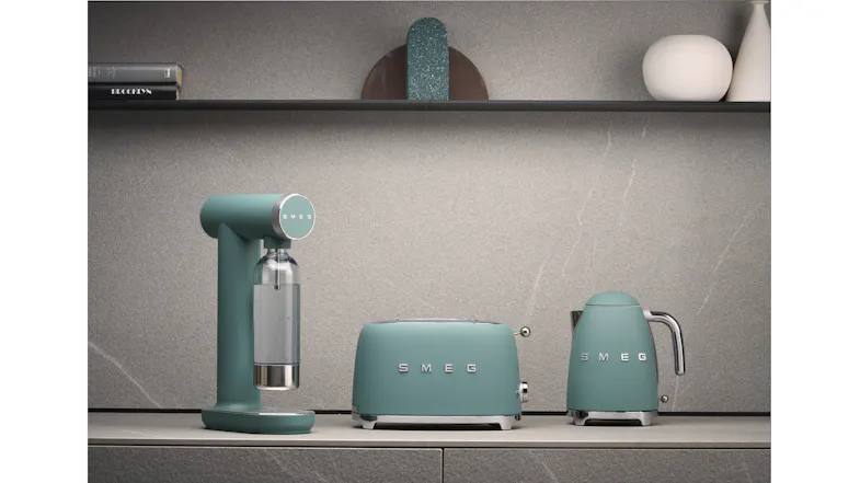 Matte emerald green Smeg Sparkling Water Maker displayed alongside matching Smeg countertop appliances Matte emerald green Smeg Sparkling Water Maker displayed alongside matching Smeg countertop appliances
