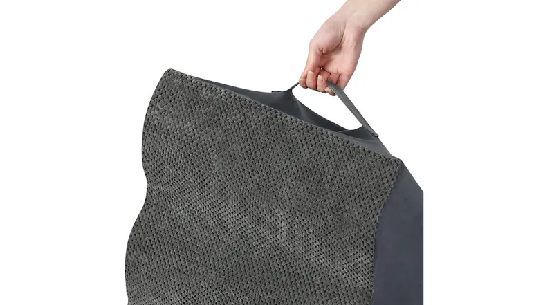 A hand lifting the grey foam pet stairs by the attached fabric handle, highlighting the lightweight and portable design A hand lifting the grey foam pet stairs by the attached fabric handle, highlighting the lightweight and portable design