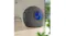 Black automatic cat litter box with a blue-tinted round entry, angled side view in a modern home setting Black automatic cat litter box with a blue-tinted round entry, angled side view in a modern home setting