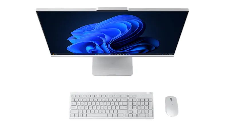Top-down angled view of the desktop with wireless keyboard and mouse, showcasing the slim display Top-down angled view of the desktop with wireless keyboard and mouse, showcasing the slim display