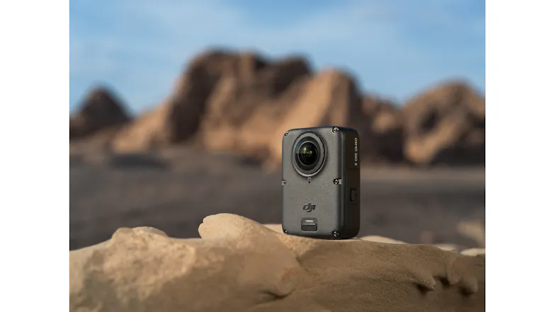 DJI Osmo 360 camera standing on a rock in a desert landscape DJI Osmo 360 camera standing on a rock in a desert landscape