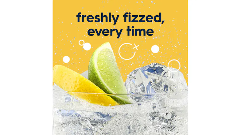 Freshly fizzed beverage with a lime wedge, lemon peel, and ice cubes in a sparkling clear drink Freshly fizzed beverage with a lime wedge, lemon peel, and ice cubes in a sparkling clear drink