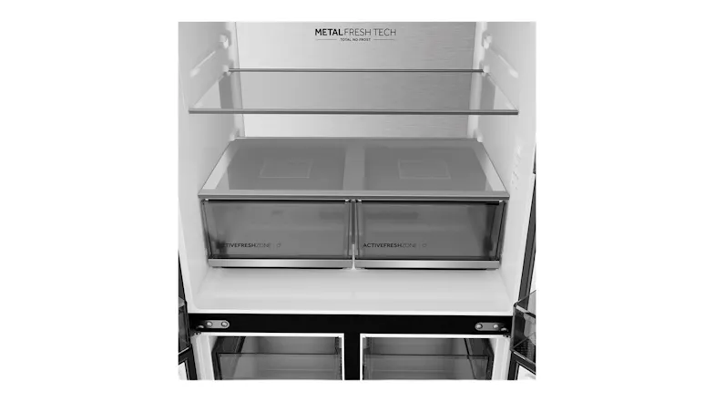 Interior view of a refrigerator compartment with glass shelves, dual crisper drawers, and a metal back panel Interior view of a refrigerator compartment with glass shelves, dual crisper drawers, and a metal back panel