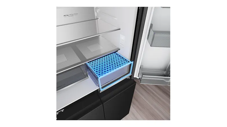 Close-up interior view of a refrigerator crisper drawer with Active Fresh Zone and a blue freshness technology display Close-up interior view of a refrigerator crisper drawer with Active Fresh Zone and a blue freshness technology display