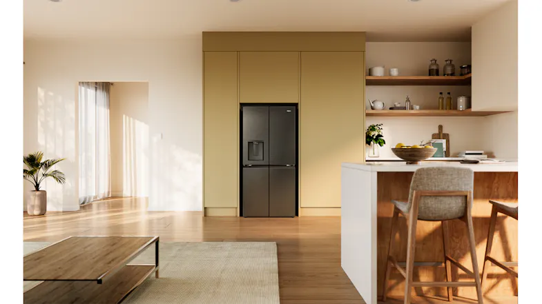 Front view of a silver Haier refrigerator with a water dispenser in a modern kitchen setting Front view of a silver Haier refrigerator with a water dispenser in a modern kitchen setting
