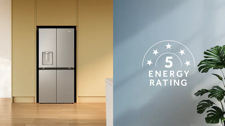 Front view of a silver Haier four-door refrigerator with a water dispenser and integrated kitchen cabinetry Front view of a silver Haier four-door refrigerator with a water dispenser and integrated kitchen cabinetry