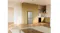 Wide-angle view of a silver Haier refrigerator installed in a modern kitchen with timber flooring Wide-angle view of a silver Haier refrigerator installed in a modern kitchen with timber flooring