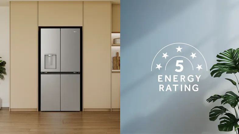 Front view of a silver Haier refrigerator installed in a modern kitchen with a 5-star energy rating Front view of a silver Haier refrigerator installed in a modern kitchen with a 5-star energy rating
