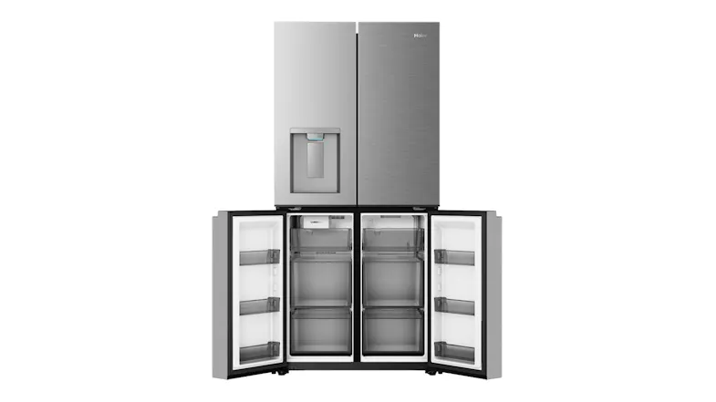 Silver refrigerator with bottom freezer doors open, revealing empty freezer drawers and door bins Silver refrigerator with bottom freezer doors open, revealing empty freezer drawers and door bins