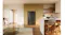 Black four-door refrigerator recessed into modern kitchen cabinetry with timber shelving and an island bench Black four-door refrigerator recessed into modern kitchen cabinetry with timber shelving and an island bench