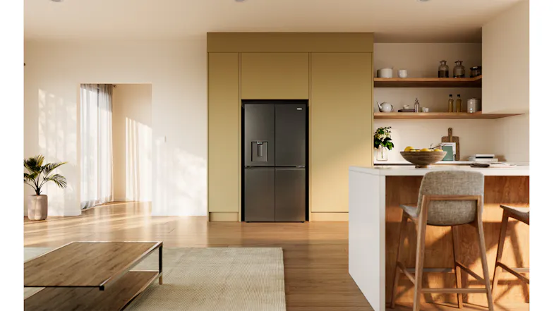Black four-door refrigerator recessed into modern kitchen cabinetry with timber shelving and an island bench Black four-door refrigerator recessed into modern kitchen cabinetry with timber shelving and an island bench