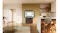 Black four-door refrigerator with the upper doors open, revealing bright interior shelves and storage compartments Black four-door refrigerator with the upper doors open, revealing bright interior shelves and storage compartments