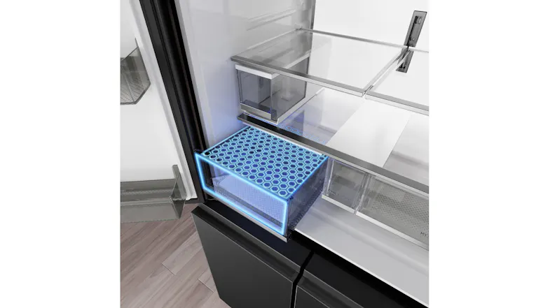 Angled close-up of a refrigerator crisper drawer with blue freshness zone illumination and glass shelving Angled close-up of a refrigerator crisper drawer with blue freshness zone illumination and glass shelving