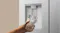 Silver refrigerator water dispenser dispensing chilled water into a clear drinking glass Silver refrigerator water dispenser dispensing chilled water into a clear drinking glass