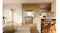 Built-in silver four-door refrigerator with upper doors open, revealing spacious interior shelving Built-in silver four-door refrigerator with upper doors open, revealing spacious interior shelving