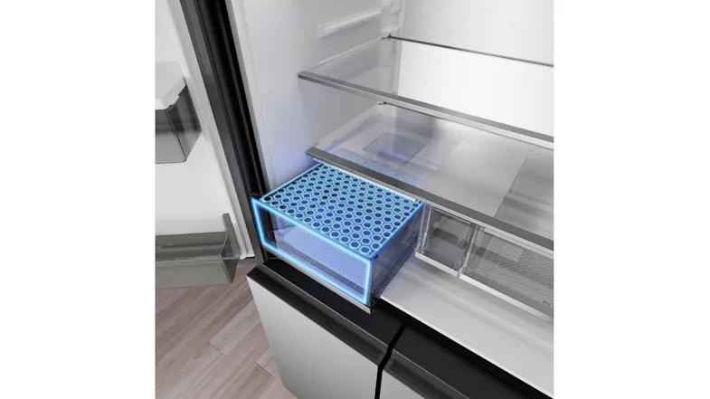 Angled interior view of a Haier refrigerator with an illuminated crisper drawer and glass shelf design Angled interior view of a Haier refrigerator with an illuminated crisper drawer and glass shelf design