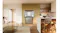 Silver Haier quad-door refrigerator with the upper doors open, showing empty shelves and crisper drawers Silver Haier quad-door refrigerator with the upper doors open, showing empty shelves and crisper drawers