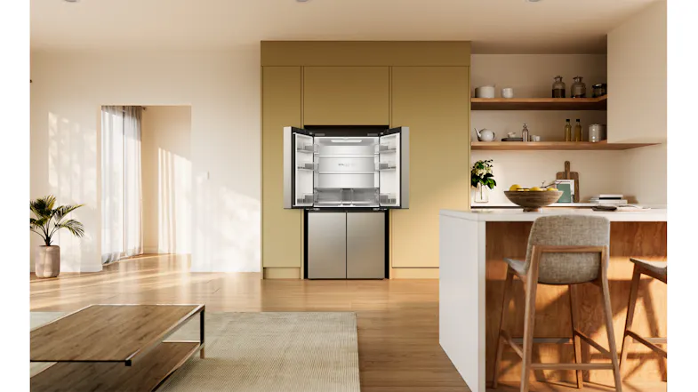 Silver Haier quad-door refrigerator with the upper doors open, showing empty shelves and crisper drawers Silver Haier quad-door refrigerator with the upper doors open, showing empty shelves and crisper drawers
