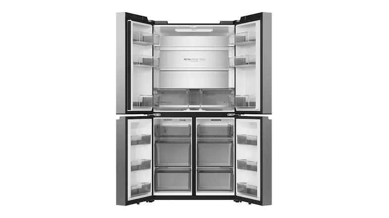 Open silver Haier four-door refrigerator with empty shelves, door bins, and lower freezer compartments Open silver Haier four-door refrigerator with empty shelves, door bins, and lower freezer compartments
