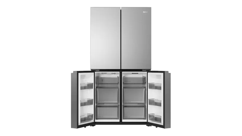Front view of a silver Haier quad-door refrigerator with the lower freezer doors open, showing empty compartments Front view of a silver Haier quad-door refrigerator with the lower freezer doors open, showing empty compartments