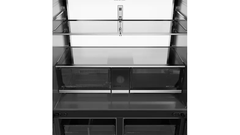 Front interior view of the refrigerator compartment with glass shelves, dual crisper drawers, and water filter housing Front interior view of the refrigerator compartment with glass shelves, dual crisper drawers, and water filter housing