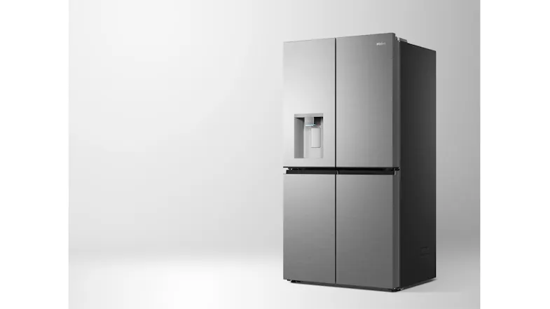 Front-angled view of a silver Haier 600 Series four-door refrigerator with an integrated water dispenser and dark side panel Front-angled view of a silver Haier 600 Series four-door refrigerator with an integrated water dispenser and dark side panel