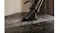 Vacuum cleaning under furniture showing low profile Vacuum cleaning under furniture showing low profile