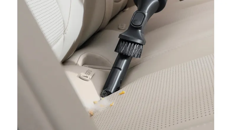 Vacuum cleaning car seat showing flexible nozzle Vacuum cleaning car seat showing flexible nozzle