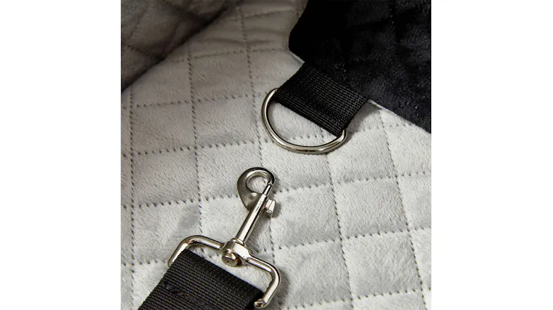 Close-up of the built-in safety tether clip attached to the seat, designed to help secure a pet during travel Close-up of the built-in safety tether clip attached to the seat, designed to help secure a pet during travel