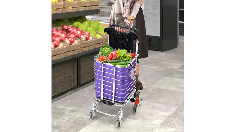 A purple folding shopping cart loaded with groceries in a supermarket aisle A purple folding shopping cart loaded with groceries in a supermarket aisle