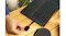 A hand inserting a SanDisk Extreme GO microSD card into a USB-C card reader connected to a laptop A hand inserting a SanDisk Extreme GO microSD card into a USB-C card reader connected to a laptop
