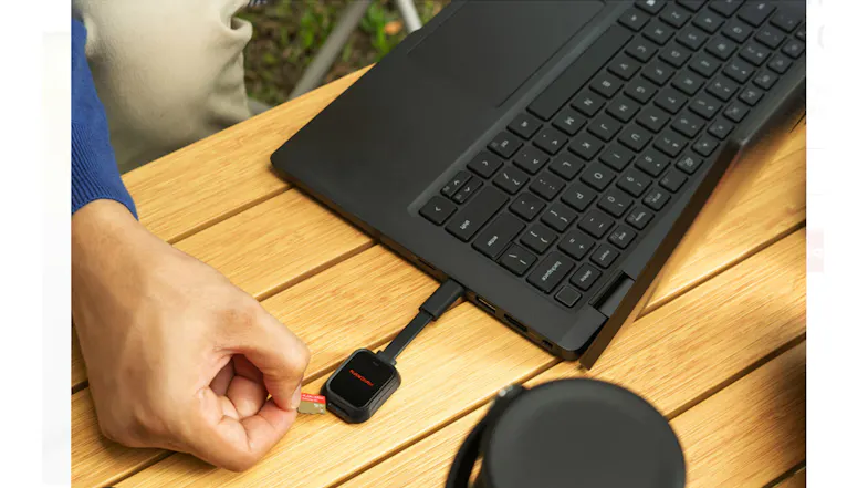 A hand inserting a SanDisk Extreme GO microSD card into a USB-C card reader connected to a laptop A hand inserting a SanDisk Extreme GO microSD card into a USB-C card reader connected to a laptop