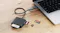 Alogic multi-card reader connected to a laptop via a braided cable, with CF, SD, and microSD cards partially inserted Alogic multi-card reader connected to a laptop via a braided cable, with CF, SD, and microSD cards partially inserted