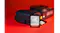 Front view of a SanDisk Ultra GO SDHC UHS-I memory card standing in front of a black camera on a red surface Front view of a SanDisk Ultra GO SDHC UHS-I memory card standing in front of a black camera on a red surface
