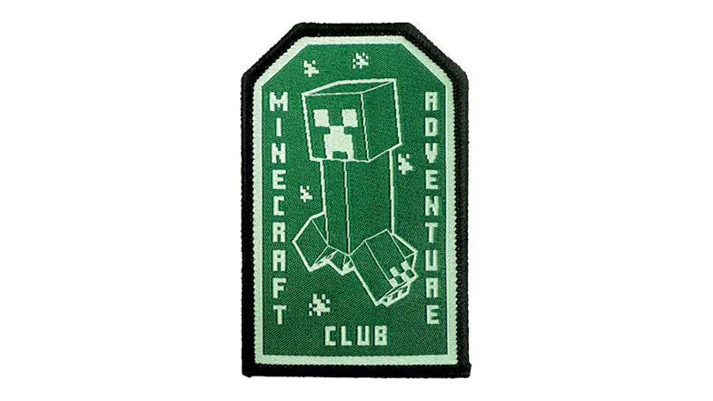 Close-Up View of a green Minecraft Adventure Club embroidered patch, featuring a Creeper design and a black border Close-Up View of a green Minecraft Adventure Club embroidered patch, featuring a Creeper design and a black border