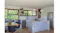 Wide shot of modern kitchen with dining area and ceiling cassette rangehood modules above Wide shot of modern kitchen with dining area and ceiling cassette rangehood modules above