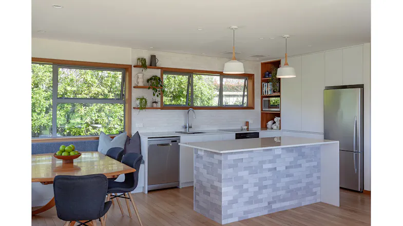 Wide shot of modern kitchen with dining area and ceiling cassette rangehood modules above Wide shot of modern kitchen with dining area and ceiling cassette rangehood modules above