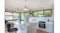 Modern kitchen island and cooktop area with twin ceiling rangehood modules above Modern kitchen island and cooktop area with twin ceiling rangehood modules above