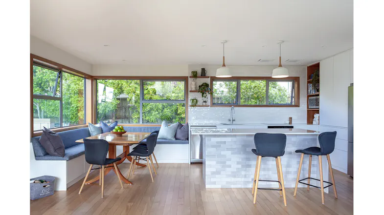 Full view of open-plan kitchen and dining space with flush-mounted ceiling rangehoods Full view of open-plan kitchen and dining space with flush-mounted ceiling rangehoods