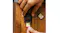 Top-down view of a SanDisk Extreme GO SD card being inserted into a black card reader on a wooden desk Top-down view of a SanDisk Extreme GO SD card being inserted into a black card reader on a wooden desk