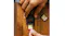 Top-down view of a SanDisk Extreme GO SD card being inserted into a black card reader on a wooden desk Top-down view of a SanDisk Extreme GO SD card being inserted into a black card reader on a wooden desk