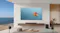 Front view of a modern living room with a wall-mounted TCL TV, soundbar, wireless speakers, and subwoofer Front view of a modern living room with a wall-mounted TCL TV, soundbar, wireless speakers, and subwoofer